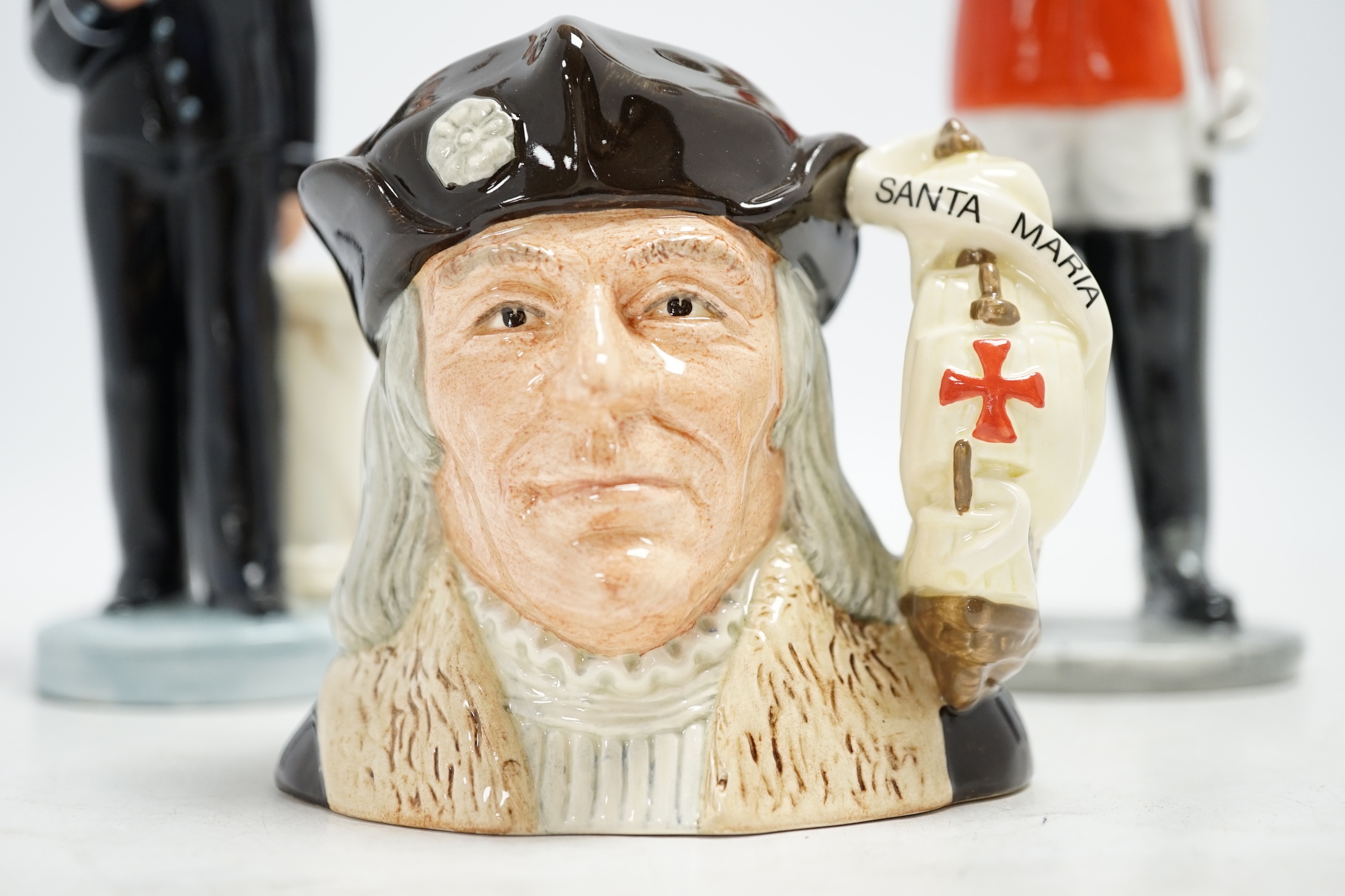 Six Royal Doulton figures including Bunny’s Bedtime, The Guardsman and The Lifeguard, together with a Christopher Columbus Toby jug, all boxed, Guardsman 25cm high. Condition - fair to good